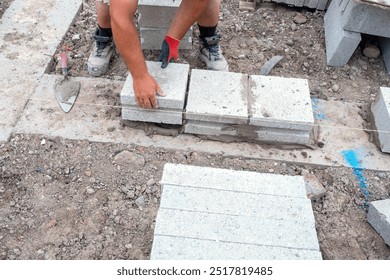 Crafting Solid Foundation With Precision Block Laying in Sunlit Construction Site