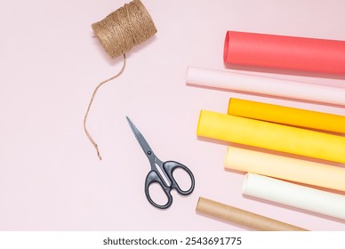 Crafting tools on pastel background with colorful rolls of paper. - Powered by Shutterstock