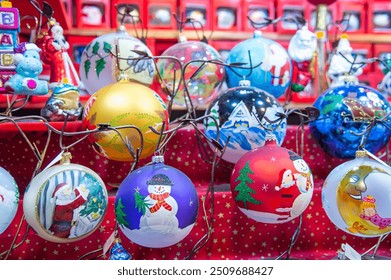 Crafts for Christmas celebrations, at the Christmas market in a wooden chalet a wide choice of Christmas baubles and decorations sometimes painted by hand to decorate the traditional tree - Powered by Shutterstock