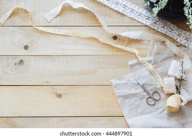 crafts concept, lace ribbon and flowering branch on wooden table - Powered by Shutterstock