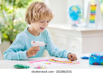 Crafts For Kids. Child With Hot Glue Gun. Creative Little Boy Sticking Buttons And Beads In Rainbow Design. Art And Creativity Class In School Or Kindergarten. Preschool Kid With Fun Diy Project.