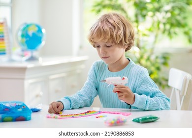 Crafts For Kids. Child With Hot Glue Gun. Creative Little Boy Sticking Buttons And Beads In Rainbow Design. Art And Creativity Class In School Or Kindergarten. Preschool Kid With Fun Diy Project.