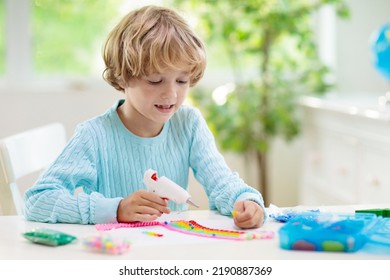 Crafts For Kids. Child With Hot Glue Gun. Creative Little Boy Sticking Buttons And Beads In Rainbow Design. Art And Creativity Class In School Or Kindergarten. Preschool Kid With Fun Diy Project.