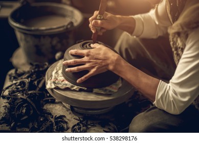 Craftsman artist making craft, pottery, sculptor from fresh wet clay on pottery wheel, selected focus - Powered by Shutterstock