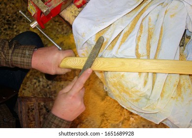 craftsman carpenter at work making a traditional bow - Powered by Shutterstock