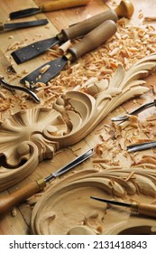Craftsman carving with a gouge. Woodwork. Workbench with equipment. Wood carving tools. Chisels for carving