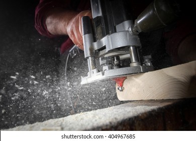 A craftsman cutting a plank of wood with band saw - Powered by Shutterstock