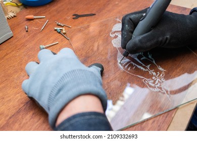 A Craftsman Does Glass Engraving With A Rotary Tool