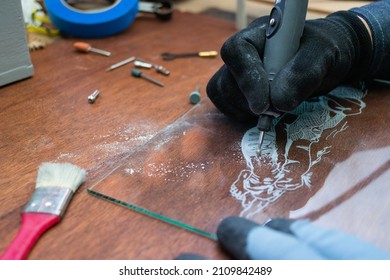 A Craftsman Does Glass Engraving With A Rotary Tool