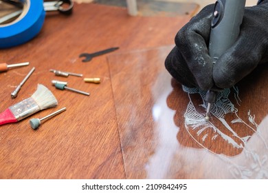 A Craftsman Does Glass Engraving With A Rotary Tool