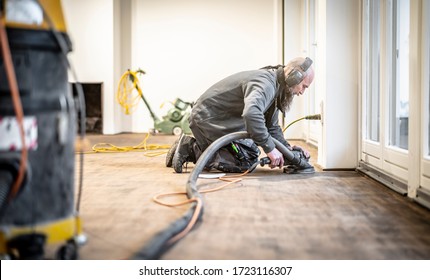 
Craftsman Grinds The Parquet Floor With The Edge Grinder