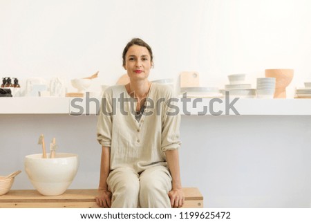 Similar – Woman in work wear in her workshop by table with handmade items