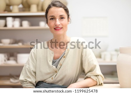 Similar – Woman in work wear in her workshop by table with handmade items