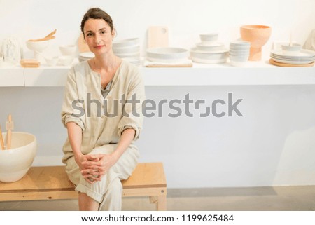 Similar – Woman in work wear in her workshop by table with handmade items