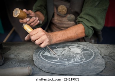 Craftsman Hands Working On A Slate Plate