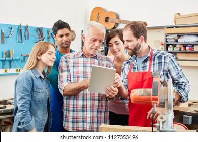 Craftsman and his team using tablet for internet training - Powered by Shutterstock