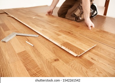 Craftsman installing engineered click system oak wood flooring