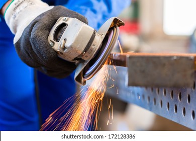 Craftsman Sawing Metal With Disk Grinder In Workshop