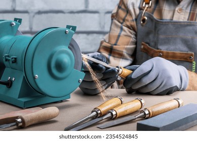  Craftsman Sharpening Work Tool On Grinder. Man At Work In Protective Workwear. - Powered by Shutterstock