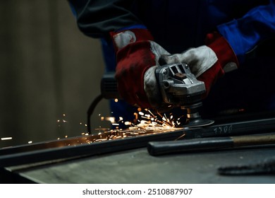 Craftsman using an angle grinder, creating bright sparks while working on a metal frame in the workshop.
