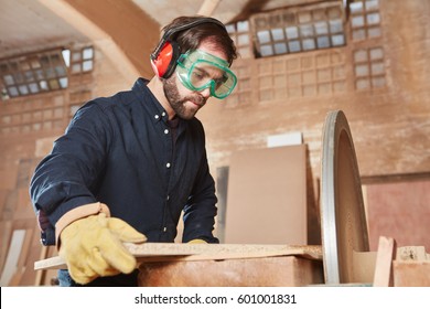 Craftsman Working With Ear Protection And Googles