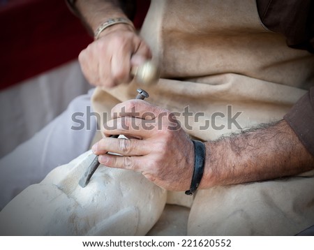 craftsman working on stone isolated on hands
