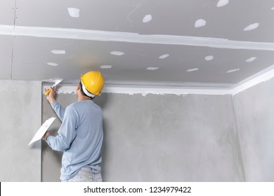 Craftsman working
with plaster gypsum ceiling for interior build gypsum board ceiling