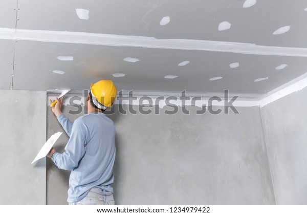 Craftsman Working With Plaster Gypsum Ceiling Stock Photo