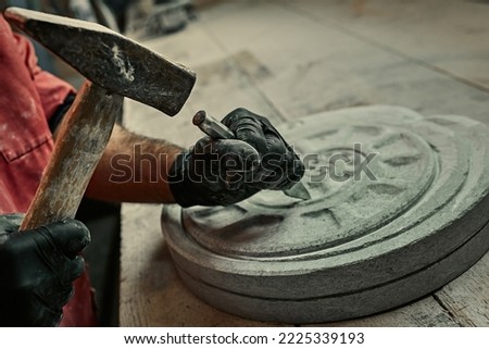 The craftsman works with stone with different tools. atmospheric photo. Sculpture making, handmade