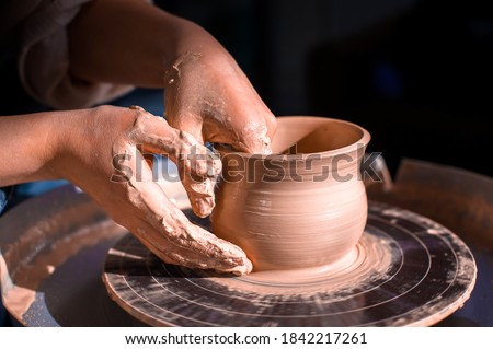 Craftsman's hands and potter's wheel. Close-up. Stock fotó © 