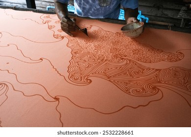 Craftsmanship of thai professional artist working use Tjanting tool or canting equipment and beeswax drawing batik ikat in handmade studio handicrafts workshop at Pak Bara of La ngu in Satun, Thailand - Powered by Shutterstock