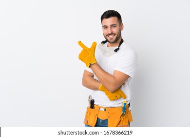 Craftsmen or electrician man over isolated white background pointing finger to the side - Powered by Shutterstock