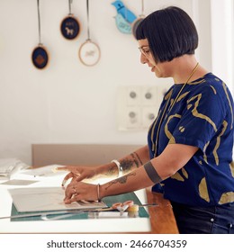 Craftswoman, light table and designer drawing in studio, working and creative professional with cutting mat for measurements. Woman, sketch and employee, planning and tracing pattern for crafts - Powered by Shutterstock