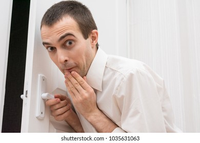 Crafty Man Opens Or Closes The Door, Covering Her Mouth In Surprise, Looking At The Camera, Emotions