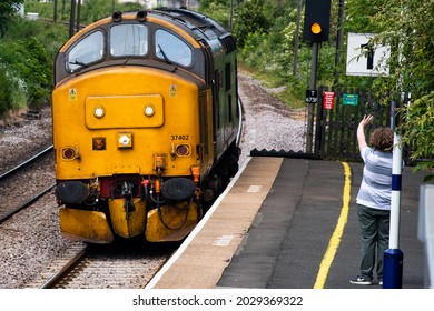 CRAMLINGTON, UNITED KINGDOM - Jun 24, 2021: A Closeup Of A Yellow Motor Car Passing Through Cramlington On The East Coast Main Line In England