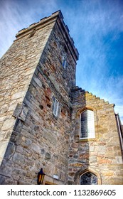Cramond, Scotland / United Kingdom - July 11 2018 : A photograph of the tower of Cramond Kirk half lit by the sun. Photograph taken in the early evening. 