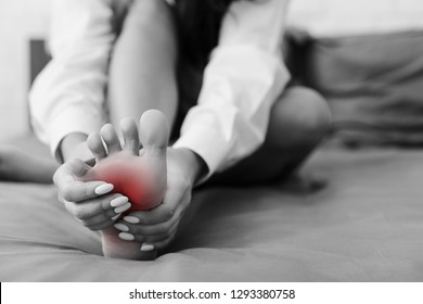 Cramp In Leg. Young Woman Massaging Her Foot, Suffering From Convulsion In Bed, Closeup