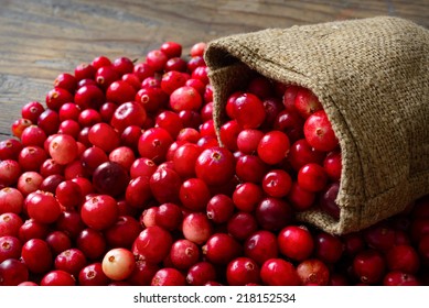 Cranberries in fabric bag on wooden background - Powered by Shutterstock