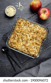 Cranberry And Apple Crumble, Crisp In A Glass Baking Dish With Almond Flakes On Dark Stone Concrete Background. Top View.