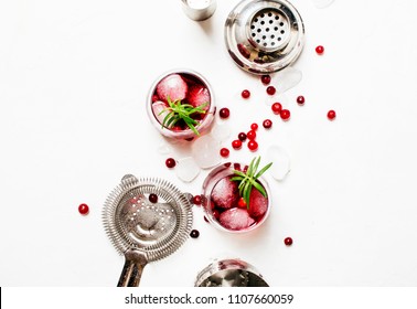 Cranberry Cocktail With Ice, Rosemary And Berries, Bar Tools, White Background, Top View