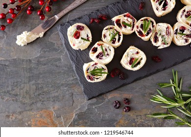 Cranberry, cream cheese pinwheel appetizers. Holiday food concept. Top view, on a dark background. - Powered by Shutterstock