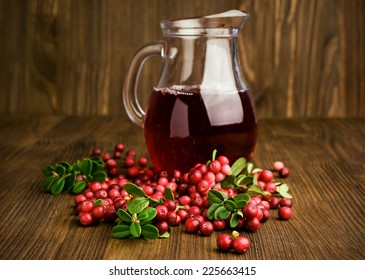 Cranberry Juice And Cranberries On Wooden Background