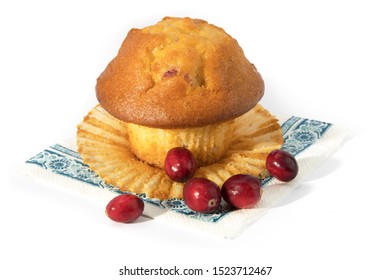 A Cranberry Lemon Muffin With Raw Cranberries On A Blue Napkin Isolated On White