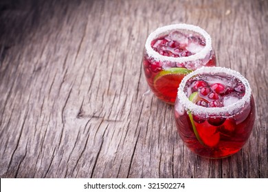 Cranberry Mojito portioned in glasses decorated with coconut. selective Focus