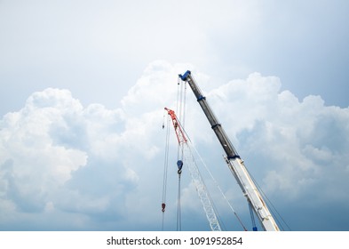 Crane with the background of the sky with clouds.