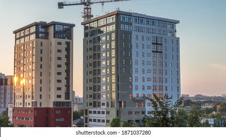 Crane And Building Construction Site Against Blue Sky Aerial Timelapse. Workers Dyeing Walls Of New Residential Appartment House