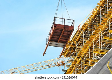 Crane and building under construction against blue sky - Shutterstock ID 651026074