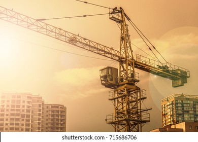 Crane. Construction crane. Building crane on the background of two buildings.