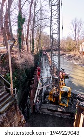 Crane Excavator For Driving Steel Sheet Piles To Stabilize The Banks Of The River Oker In Brunswick, Germany, March 8, 2021