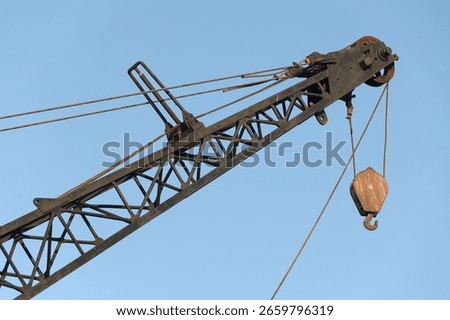 Crane hook construction on a blue sky background
